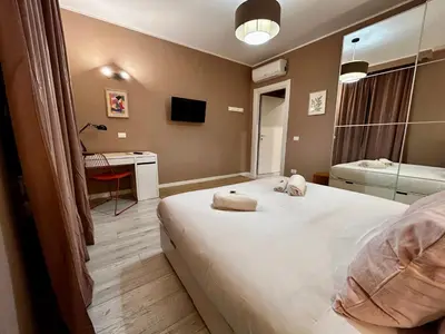 a bedroom with a large bed with towels on it at Provincie 55 in Rome