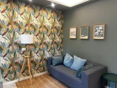 a living room with a couch and a colorful wallpaper at Provincie 55 in Rome