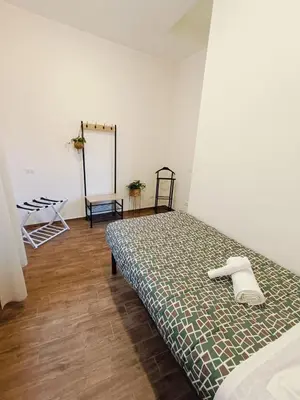a bedroom with a bed with a comforter on it at Dolceborgo al Vaticano in Rome