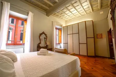 a bedroom with a white bed and a mirror at Borgo Pio 64 - Vatican City in Rome