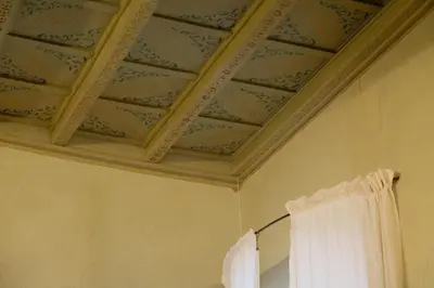 a room with a ceiling with a curtain and a mirror at Borgo Pio 64 - Vatican City in Rome