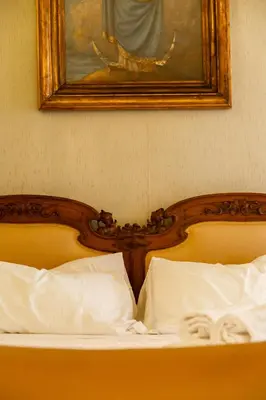 two beds with white pillows and a picture on the wall at Borgo Pio 64 - Vatican City in Rome