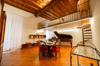 a dining room with a table and a loft at Borgo Pio 64 - Vatican City in Rome