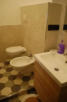 a bathroom with a toilet and a sink at Interno Sette in Rome