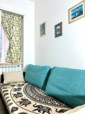 a couch sitting in a living room next to a window at Interno Sette in Rome
