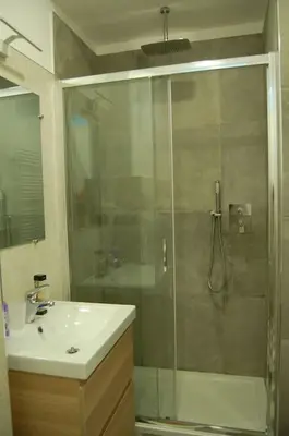 a bathroom with a glass shower and a sink at Interno Sette in Rome