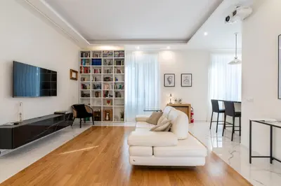a living room with a white couch and a tv at Elegante Appartamento presso Vaticano in Rome
