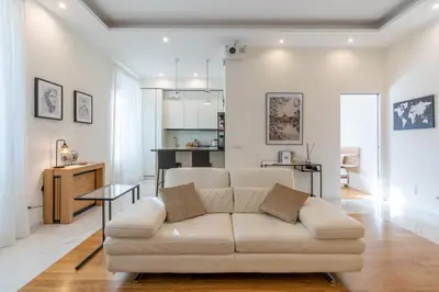 a living room with a white couch and a table at Elegante Appartamento presso Vaticano in Rome