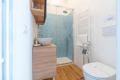 a bathroom with a toilet and a sink and a shower at Elegante Appartamento presso Vaticano in Rome