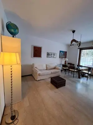 a living room with a couch and a table at Casa Nisio - Gemelli comoda e accogliente in Rome