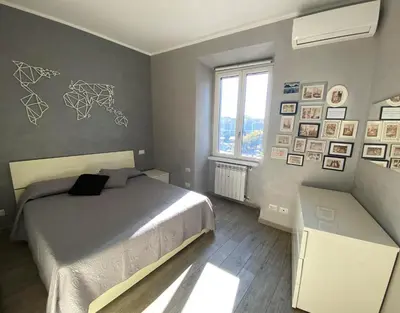 a bedroom with a bed and pictures on the wall at Lola's house in Rome