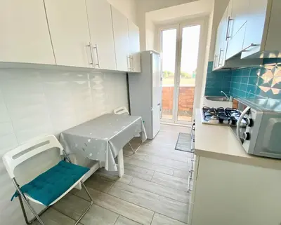 a kitchen with a table and a sink in it at Lola's house in Rome