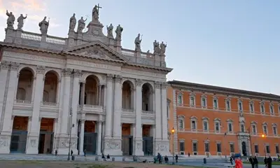 a large building with people standing in front of it at Lola's house in Rome