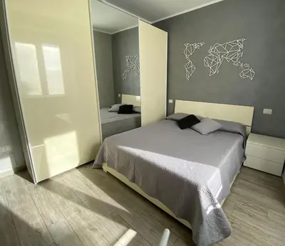 a bedroom with a large bed and a mirror at Lola's house in Rome
