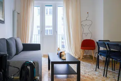 a living room with a couch and a table and chairs at The Twenty - Vatican Apartment in Rome