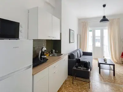 a kitchen with a sink and a couch in a room at The Twenty - Vatican Apartment in Rome