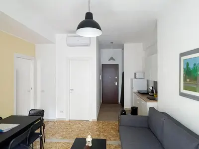 a living room with a couch and a table at The Twenty - Vatican Apartment in Rome