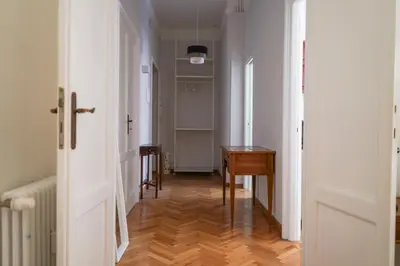 a hallway with a table and a desk in a room at The Twenty - Mazzini apartment in Rome