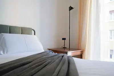 a bedroom with a bed and a window at The Twenty - Mazzini apartment in Rome