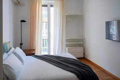 a bedroom with a white bed and a window at The Twenty - Mazzini apartment in Rome