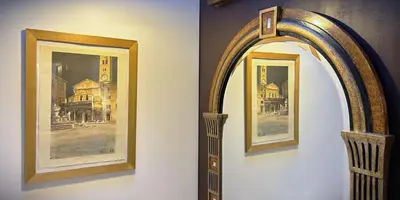 two framed pictures on a wall with a mirror at The Gem - Trastevere Cozy Retreat with pool in Rome