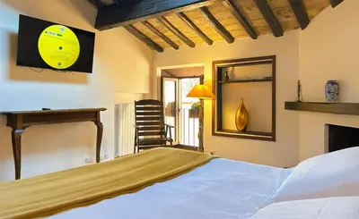 a bedroom with a bed and a fireplace and a mirror at The Gem - Trastevere Cozy Retreat with pool in Rome