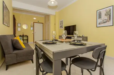 a dining room with a table with chairs and wine glasses at Your Whole Suite in Rome