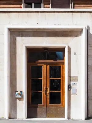 a wooden door in the front of a building at C'est La Vie Suites in Rome