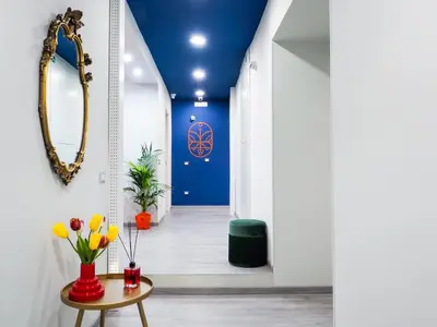 a hallway with a mirror and a table with flowers at C'est La Vie Suites in Rome