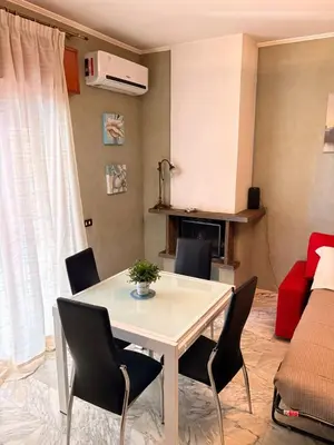 a living room with a white table and chairs at Casa di Eli in Rome