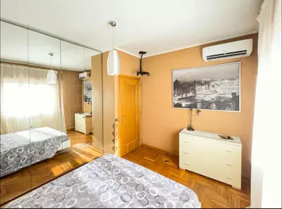 a bedroom with a bed and a dresser and a mirror at Casa di Eli in Rome