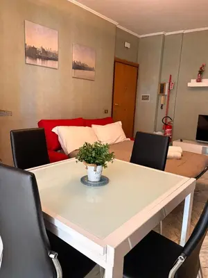 a living room with a table and a couch at Casa di Eli in Rome