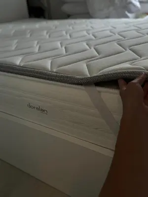 a person is laying on a firm mattress at Ponte Milvio Suite & Parking- La Chambre de Sophie in Rome
