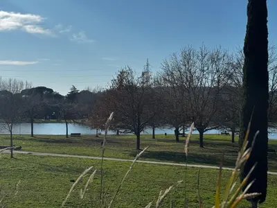 a park with a body of water and trees at Ponte Milvio Suite & Parking- La Chambre de Sophie in Rome