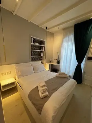 a bedroom with a large bed with towels on it at Ponte Milvio Suite & Parking- La Chambre de Sophie in Rome