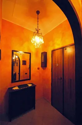 a bathroom with a mirror and a chandelier at Ababaluba - Colosseo - San Giovanni in Rome