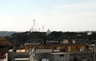 a view of a city with a hill in the background at Ababaluba - Colosseo - San Giovanni in Rome