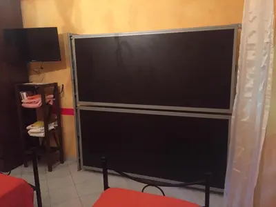 a large screen television sitting in a room at Ababaluba - Colosseo - San Giovanni in Rome