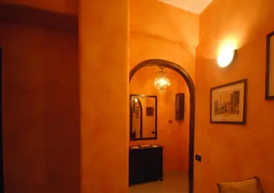 a hallway with an archway in a room at Ababaluba - Colosseo - San Giovanni in Rome