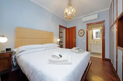 a bedroom with a large white bed with towels on it at La Petite Urbana Apartment in Rome