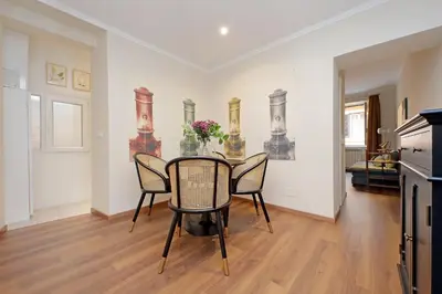 a dining room with a table and chairs at La Petite Urbana Apartment in Rome