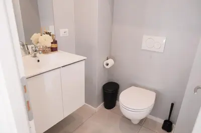 a white bathroom with a toilet and a sink at Numi B&B in Rome