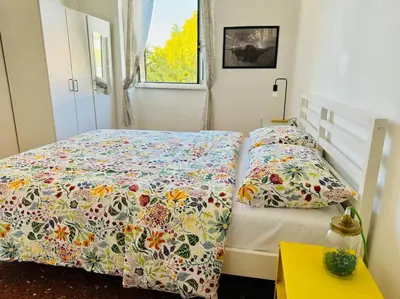 a kitchen with white cabinets and a table and chairs at Casa Rica at Vatican and St Peter in Rome