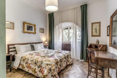 a bedroom with a bed and a desk and a window at BelleArtiHome2 in Rome