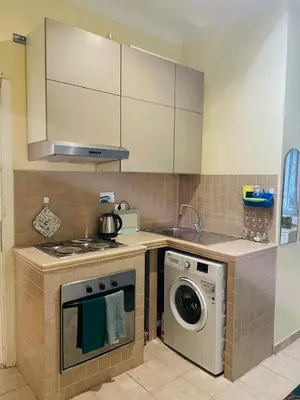 a kitchen with a stove and a washing machine at Casa intera vicino il centro per 4 persone in Rome
