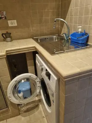 a bathroom with a washing machine and a sink at Casa intera vicino il centro per 4 persone in Rome
