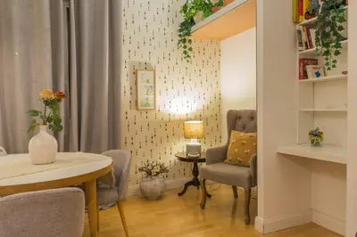 a living room with a table and chairs and a desk at Appartamento Sofia in Rome