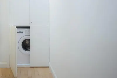 a white laundry room with a washer and dryer at Appartamento Sofia in Rome