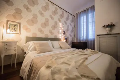 a bedroom with a large white bed and a window at Appartamento Sofia in Rome