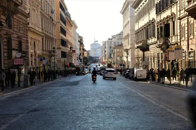 a person riding a scooter down a city street at Appartamento Sofia in Rome